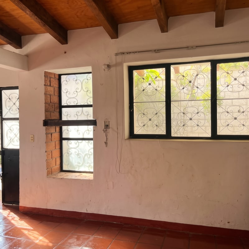Living room in a single floor house for sale real estate on a quiet cobblestone street in El Centro, Oaxaca de Juarez, Mexico