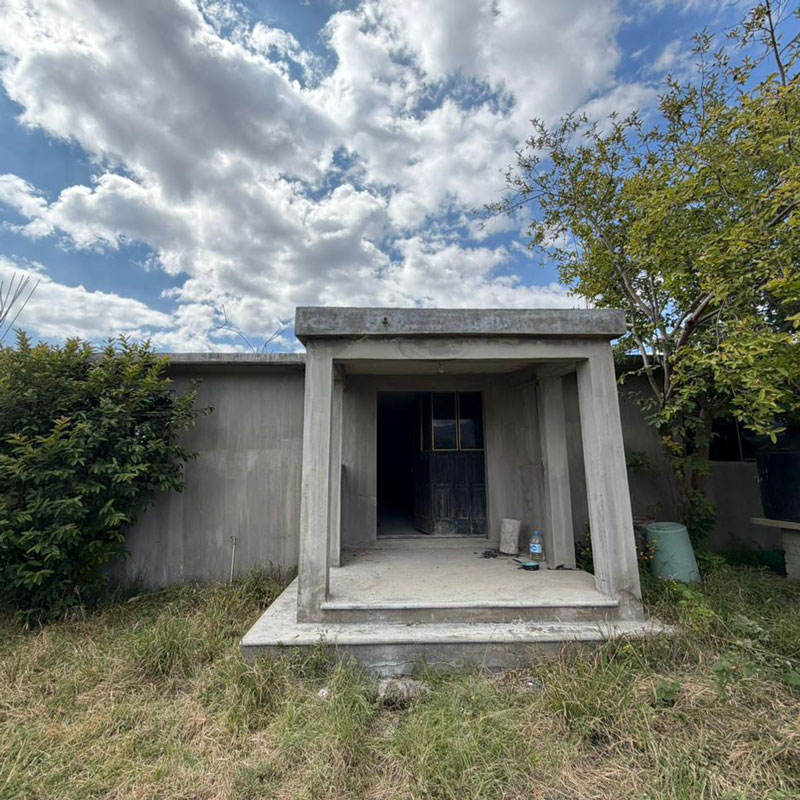 Exterior of unfinished cement block house in San Lorenzo Cacaotepec, Oaxaca, Mexico for sale with lots of land on large lot.