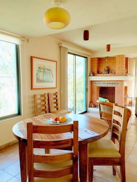 Dining room beside the fireplace on the first floor of this casa en venta in Loma Linda, Oaxaca, Mexico