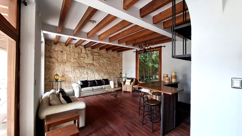 Living room with hardwood floors, wooden beam ceiling and bar stools — San Felipe del Agua house for sale