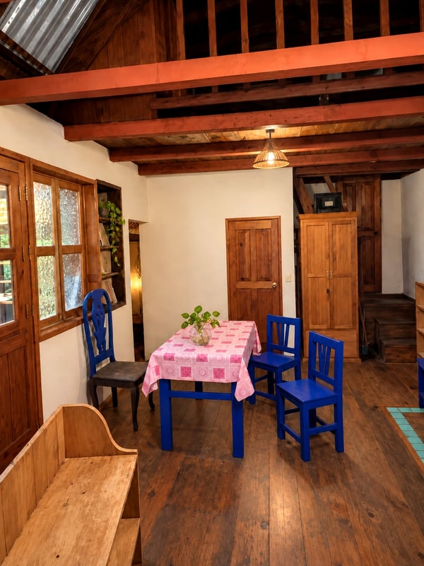 Living room of the furnished guest house, wood interior in a two house mountain retreat for sale in Oaxaca, Mexico