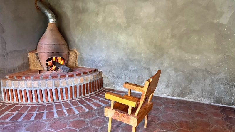 Fireplace in the main living space of the main house, cool climate mountain home for sale at 2,300 meters in Oaxaca