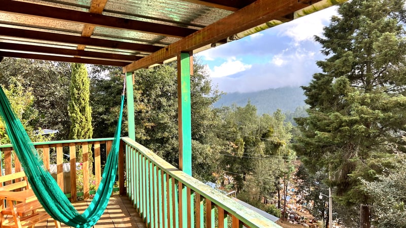 Veranda deck off the main house looking out over forested mountain ridges, Oaxaca mountain real estate for sale with two dwellings
