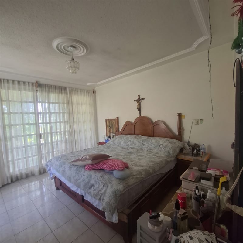 Master bedroom with floor to ceiling glass doors opening onto the second floor terrace, San Antonio de la Cal real estate