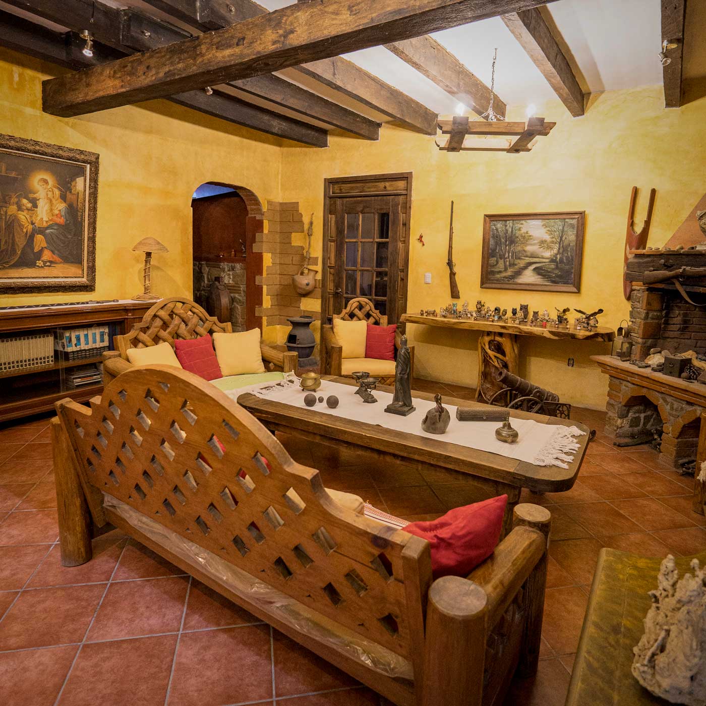Colonial rustic living room with hand carved wooden sofas and wood beam ceiling in Tlalixtac de Cabrera luxury house for sale