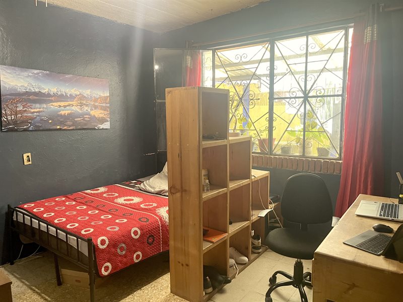 Bedroom with garden window, desk and shelving divider in a three bedroom house for sale near Oaxaca city