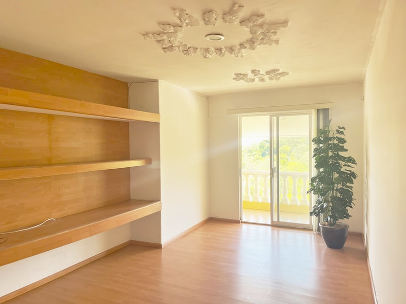 Television room on the second floor landing with wooden shelving in an Oaxaca house for rent